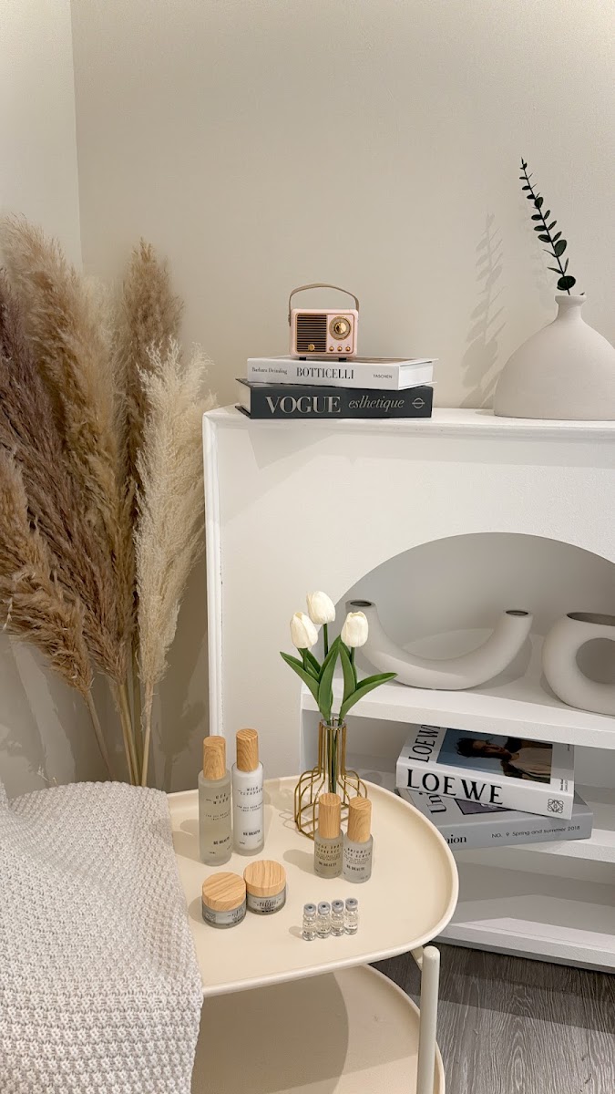 Be Beaute own-label skincare products styled on a cream side table